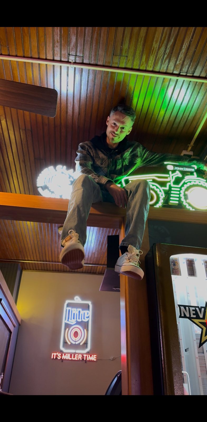 Hanging out under the John Deere neon sign
