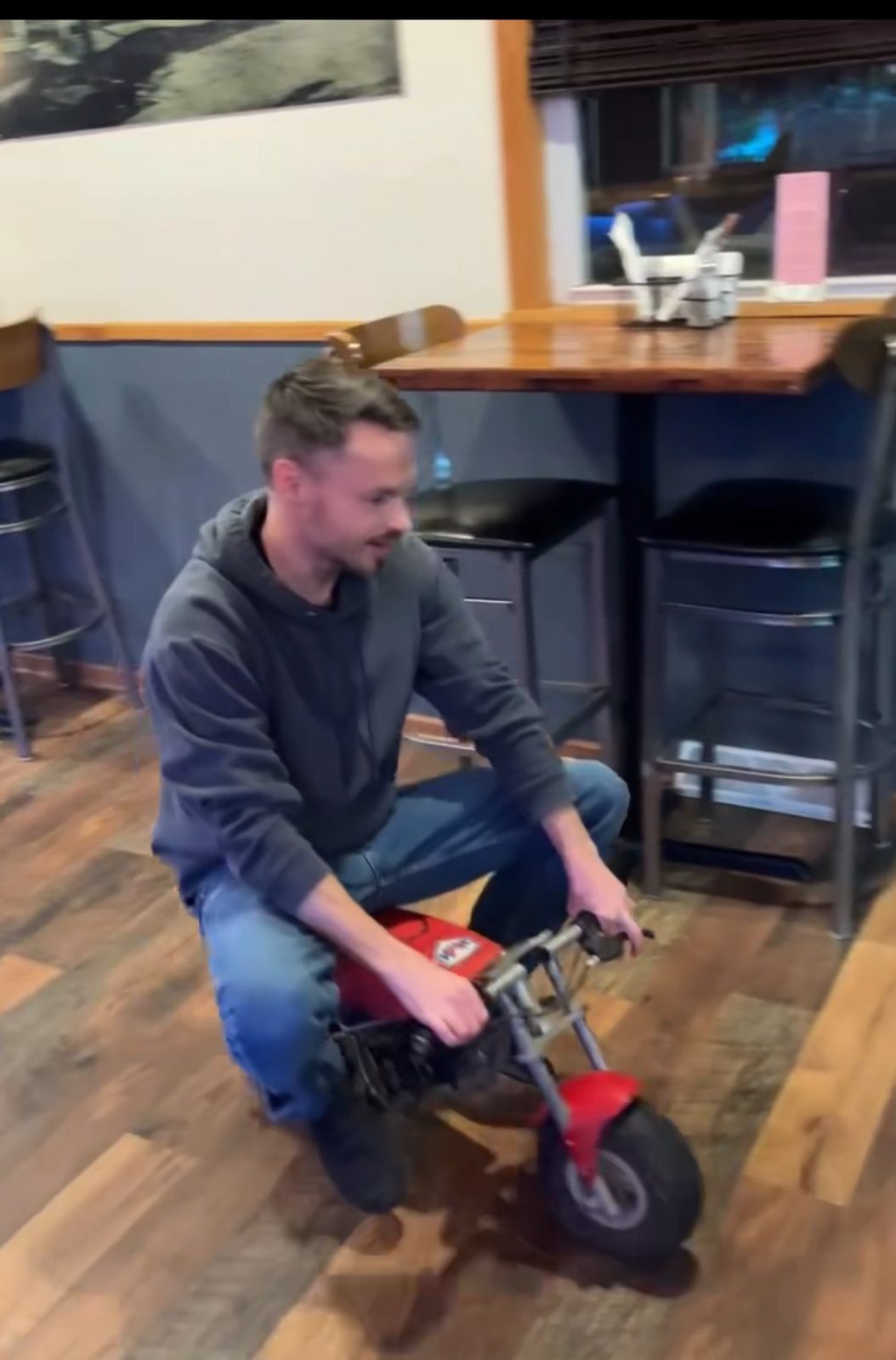 Riding a mini bike inside the tavern