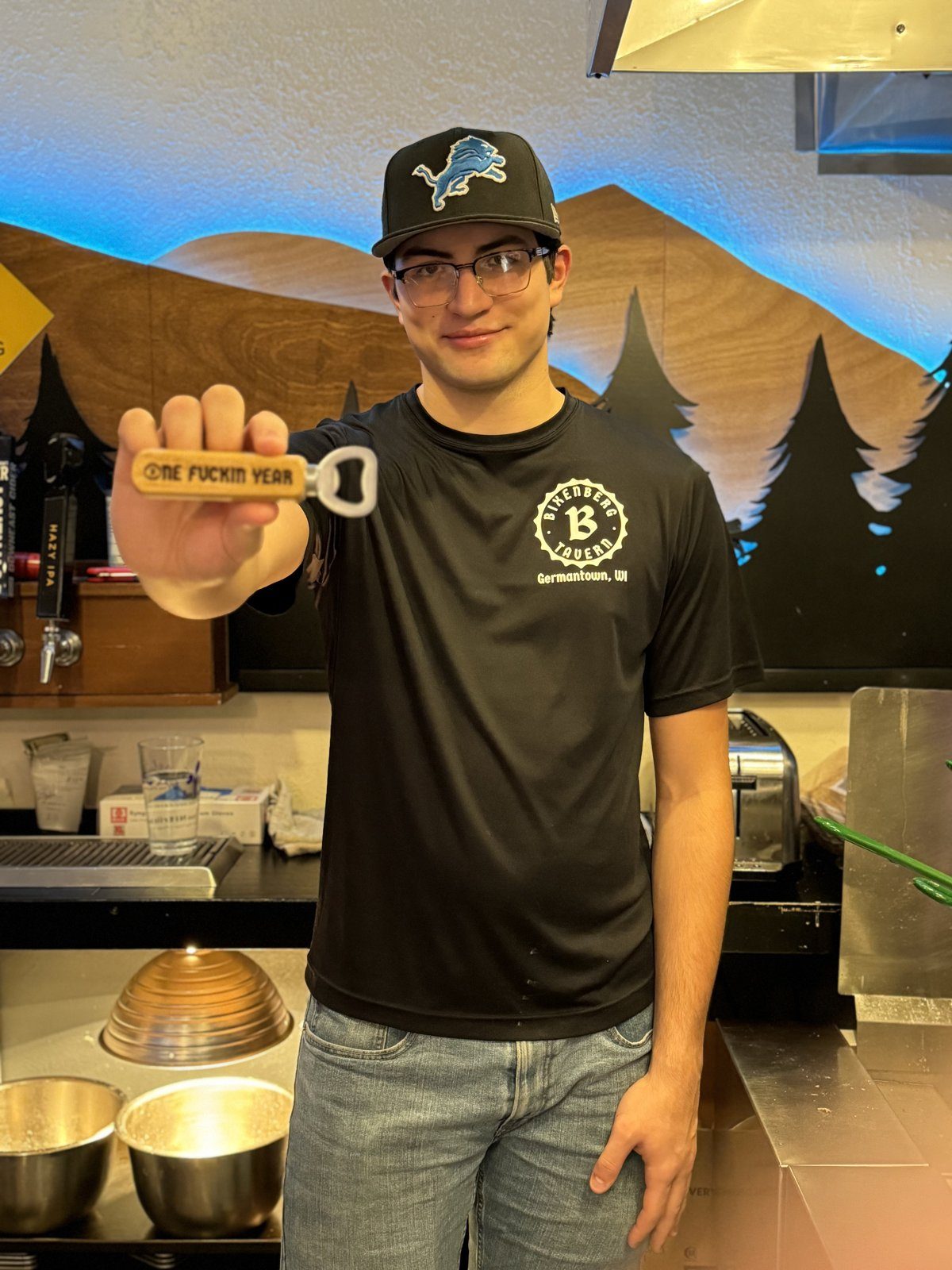 Staff member with anniversary bottle opener